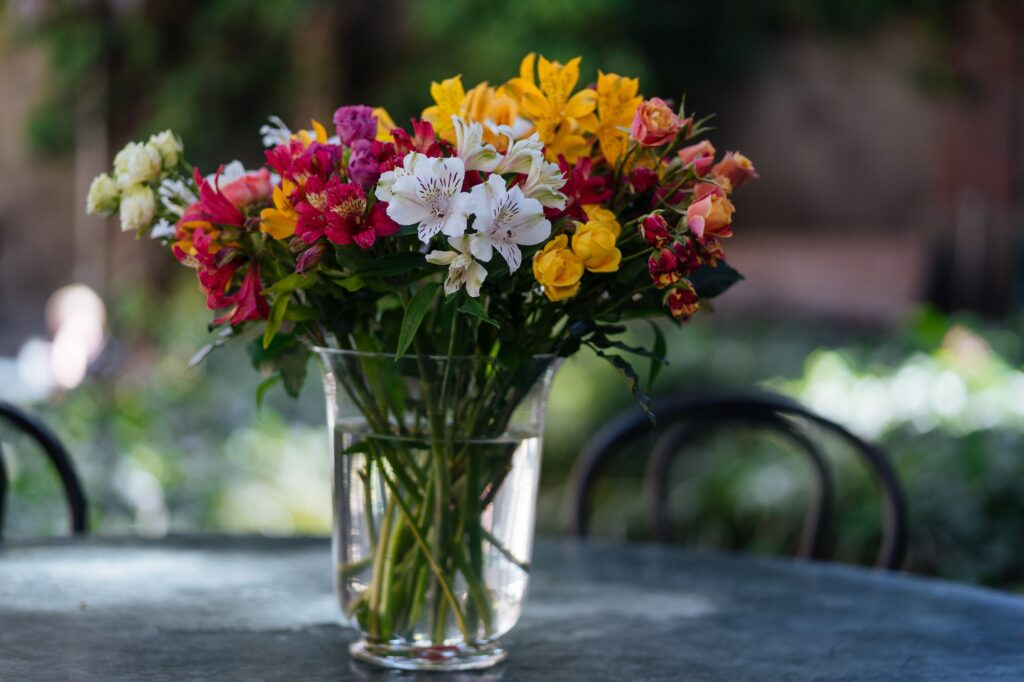 Bright flowers in vase on table