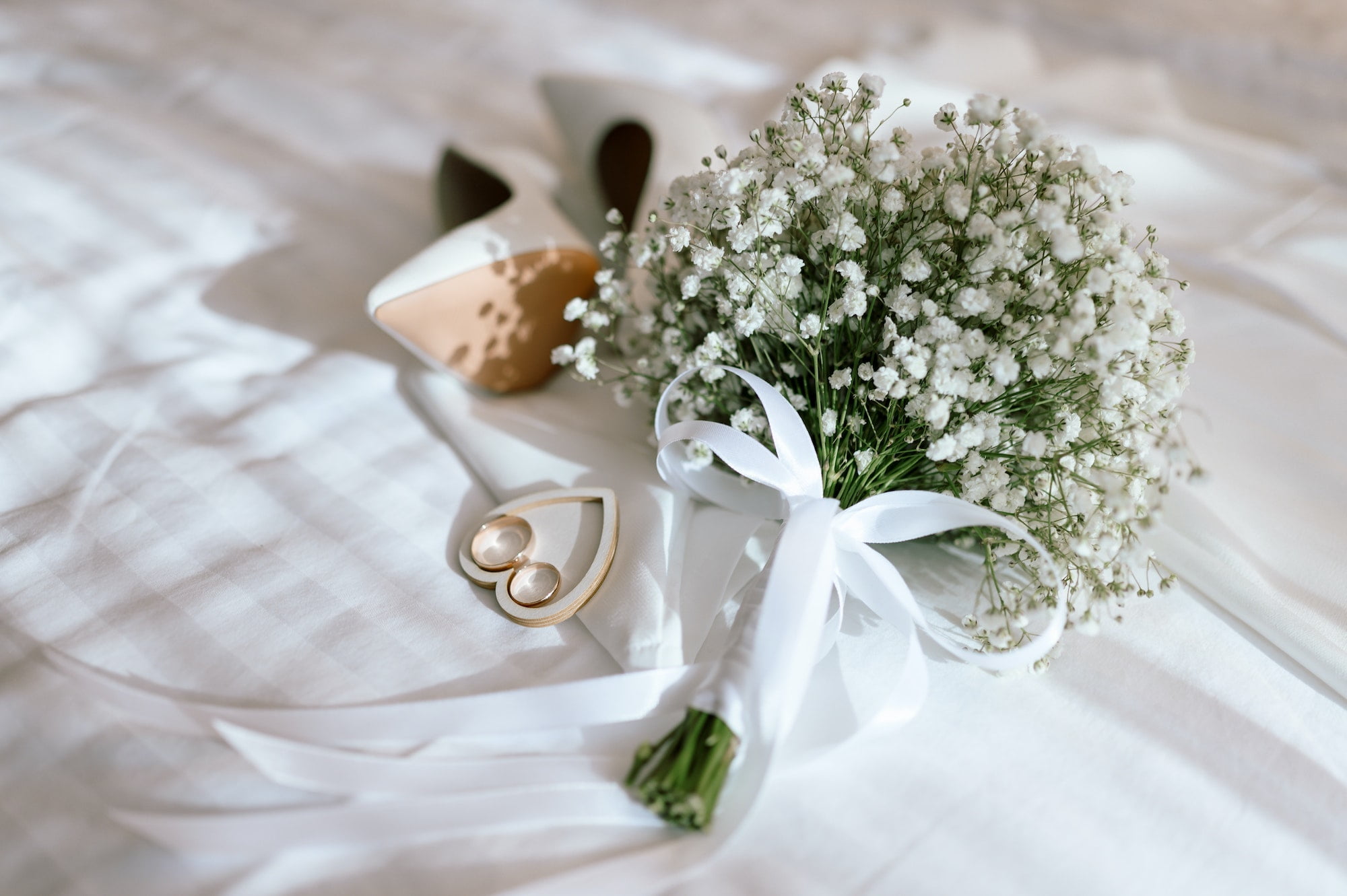 Wedding flowers with shoes and wedding rings